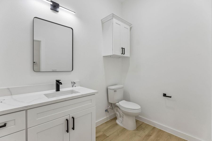 Clean lines and stone counters define this modern powder room.
