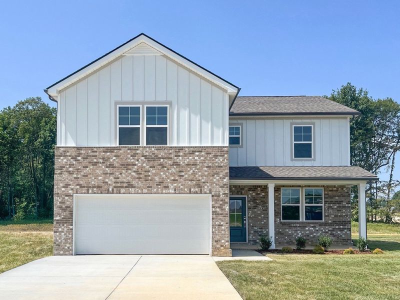 Front exterior of a new home in Highland Reserves, Pleasant View, TN, highlighting curb appeal (Image 1).