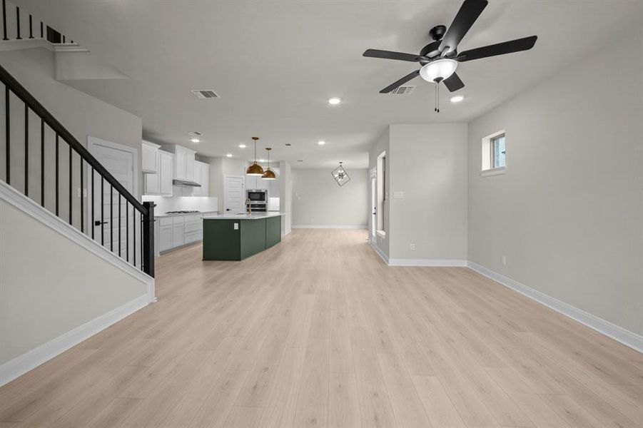 Unfurnished living room with a ceiling fan, light wood-style flooring, and recessed lighting