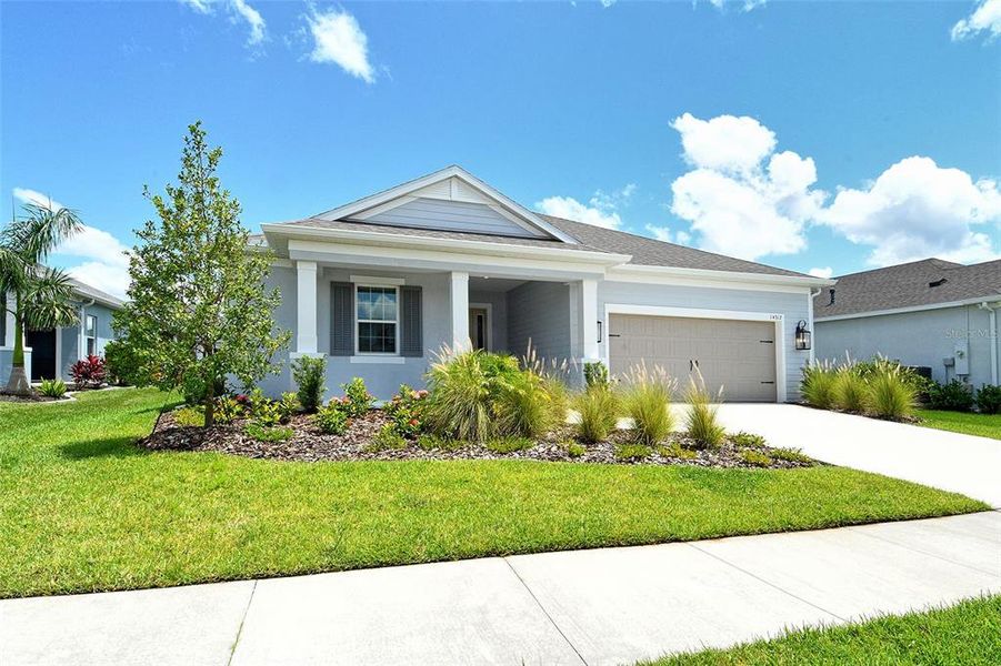 Front exterior of a new home in Canoe Creek, Parrish, FL, highlighting curb appeal (Image 18).