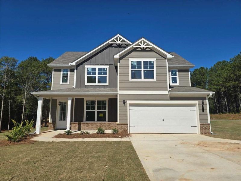 Front exterior of a new home in Waters Edge, Mansfield, GA, highlighting curb appeal (Image 2). Front exterior of a new home in Waters Edge, Mansfield, GA, highlighting curb appeal (Image 2).