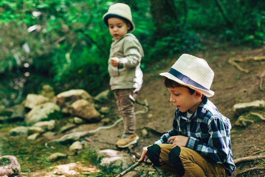 Young Boys Fishing In A River.