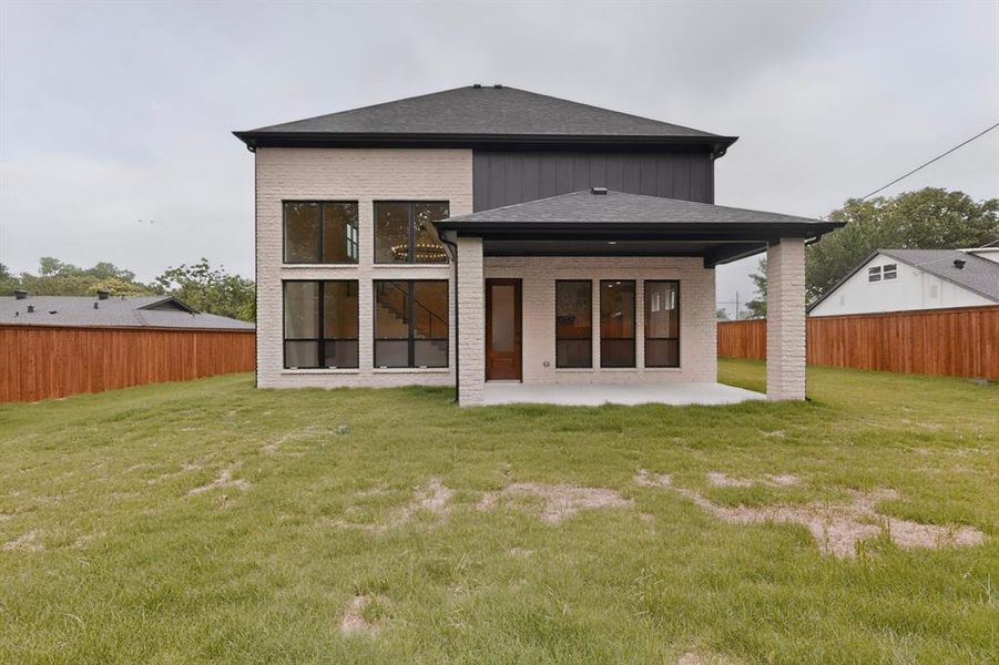 Contemporary two-story exterior featuring light brick and dark siding accents