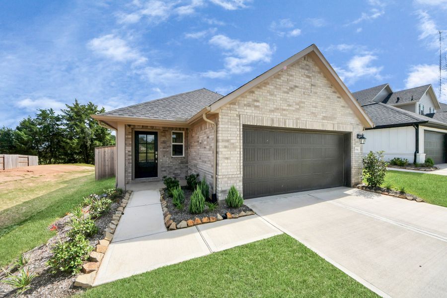 Front exterior of a new home in Montgomery Ridge, Montgomery, TX, highlighting curb appeal (Image 1). Front exterior of a new home in Montgomery Ridge, Montgomery, TX, highlighting curb appeal (Image 1).