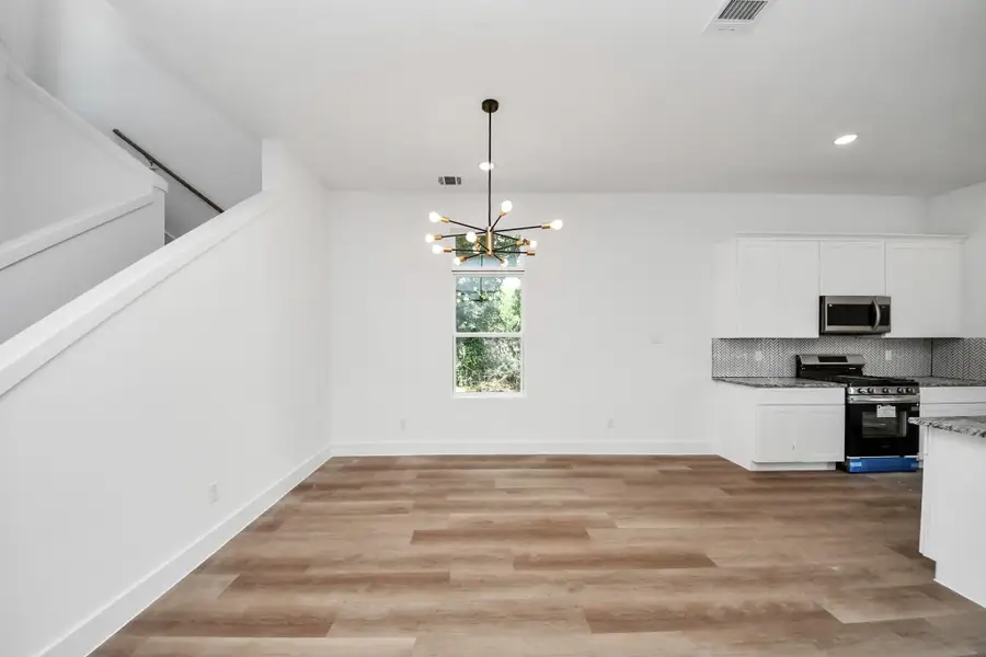 Dining room with natural light and modern light fixture.
