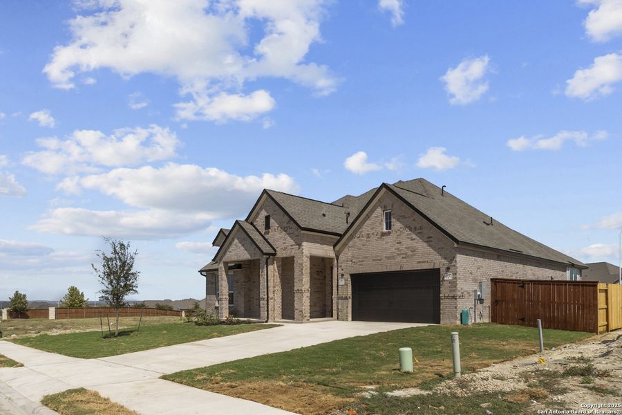 Front exterior of a new home in Homestead 75', Schertz, TX, highlighting curb appeal (Image 19).