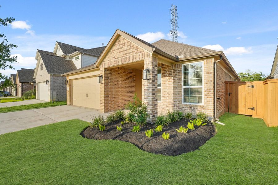 Front exterior of a new home in Sunterra North, Katy, TX, highlighting curb appeal (Image 11). Front exterior of a new home in Sunterra North, Katy, TX, highlighting curb appeal (Image 11).