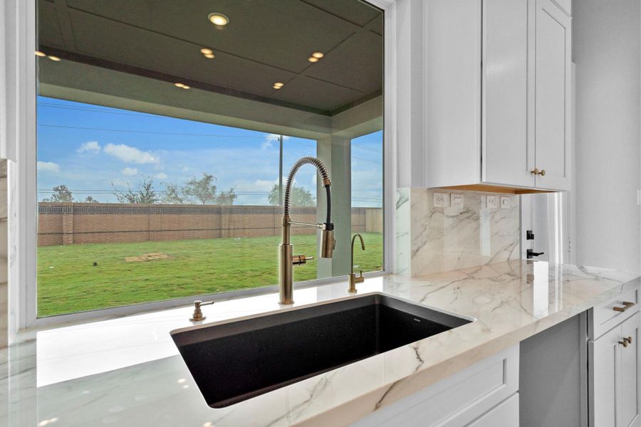 Kitchen sink overlooking the covered patio and backyard.