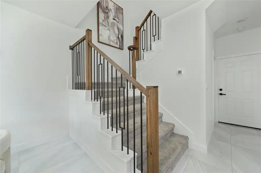 Stairs featuring baseboards and marble finish flooring