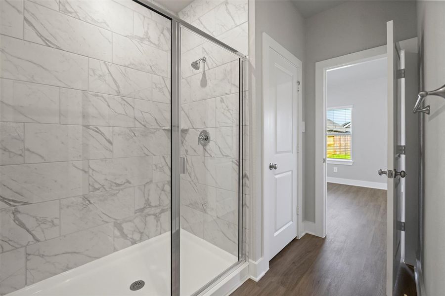 Elegant ensuite with dual vanities and separate glass shower.