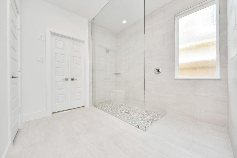 Indulge in a spa-like retreat within the confines of this primary bathroom. Delight in a spacious walk-in shower enveloped in stylish tile surround. Indulge in a spa-like retreat within the confines of this primary bathroom. Delight in a spacious walk-in shower enveloped in stylish tile surround.