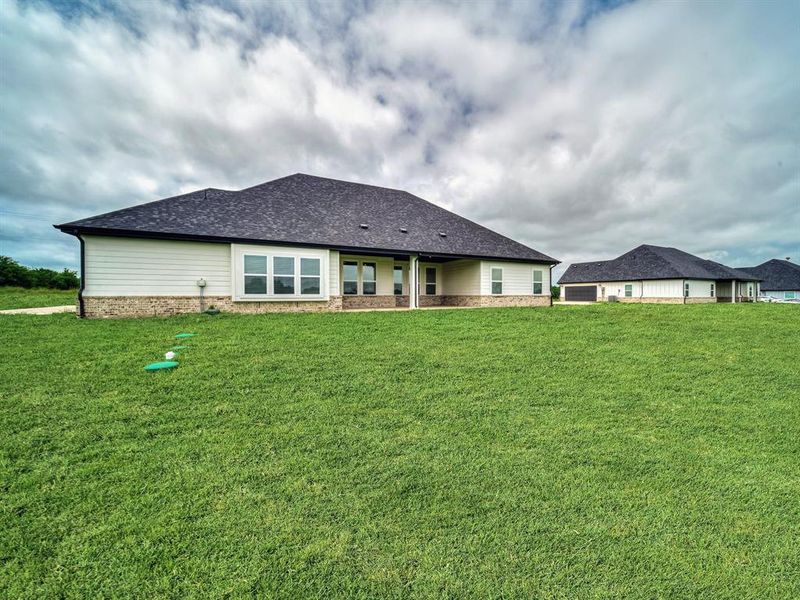 Front exterior of a new home in , Celeste, TX, highlighting curb appeal (Image 19).