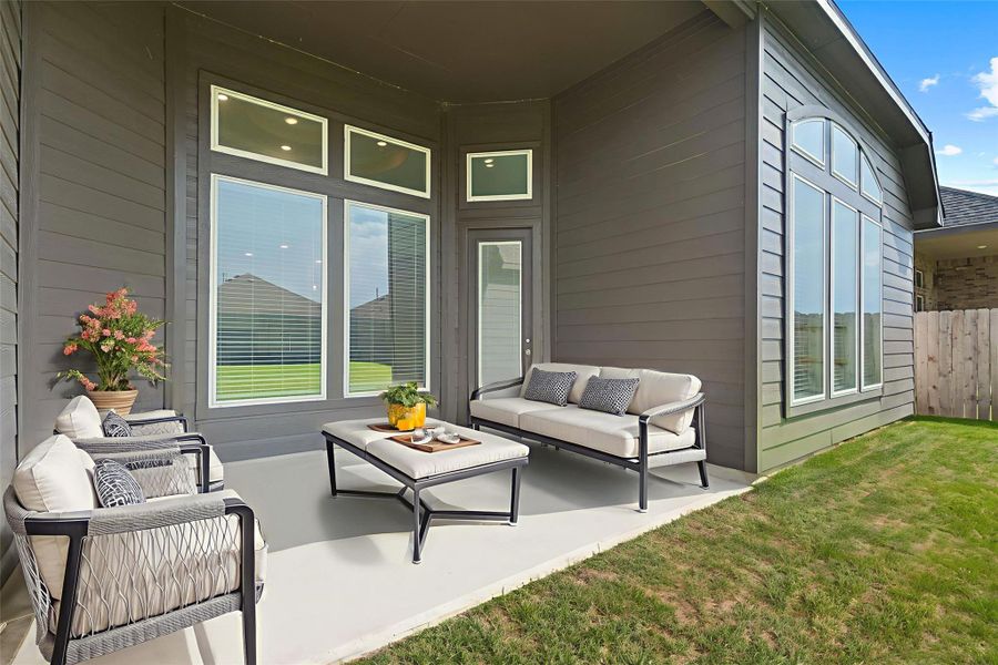 Covered back patio (virtually staged) creating the perfect spot for outdoor dining, morning coffee, or evening relaxation.