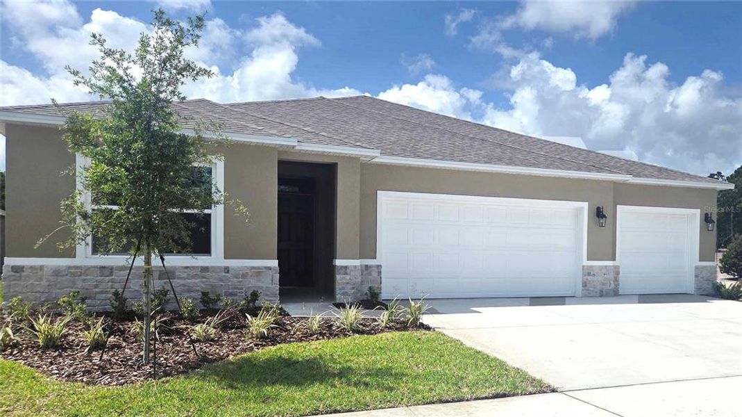 Front exterior of a new home in Wexford Cove, Ormond Beach, FL, highlighting curb appeal (Image 1). Front exterior of a new home in Wexford Cove, Ormond Beach, FL, highlighting curb appeal (Image 1).