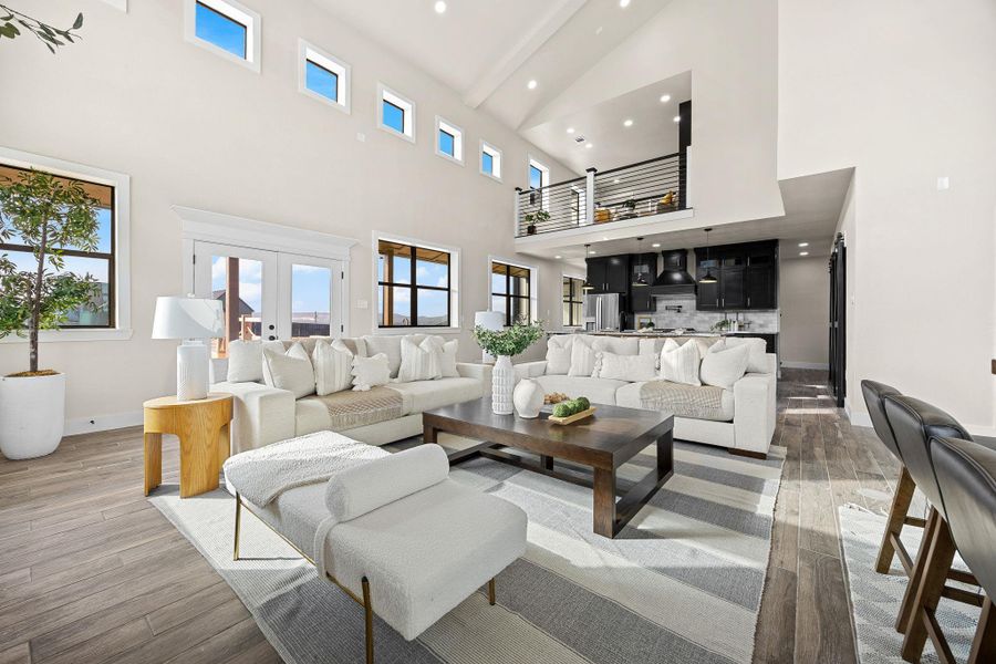 Living room with beamed ceiling, light wood finished floors, recessed lighting, and french doors Living room with beamed ceiling, light wood finished floors, recessed lighting, and french doors