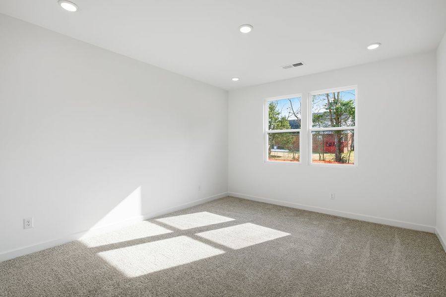 A room with a window and a rug in it. A room with a window and a rug in it.