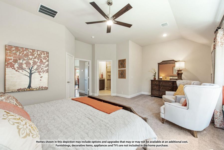 Spacious master bedroom with vaulted ceiling, ceiling fan, carpet flooring, and ensuite bathroom doorway visible. Spacious master bedroom with vaulted ceiling, ceiling fan, carpet flooring, and ensuite bathroom doorway visible.
