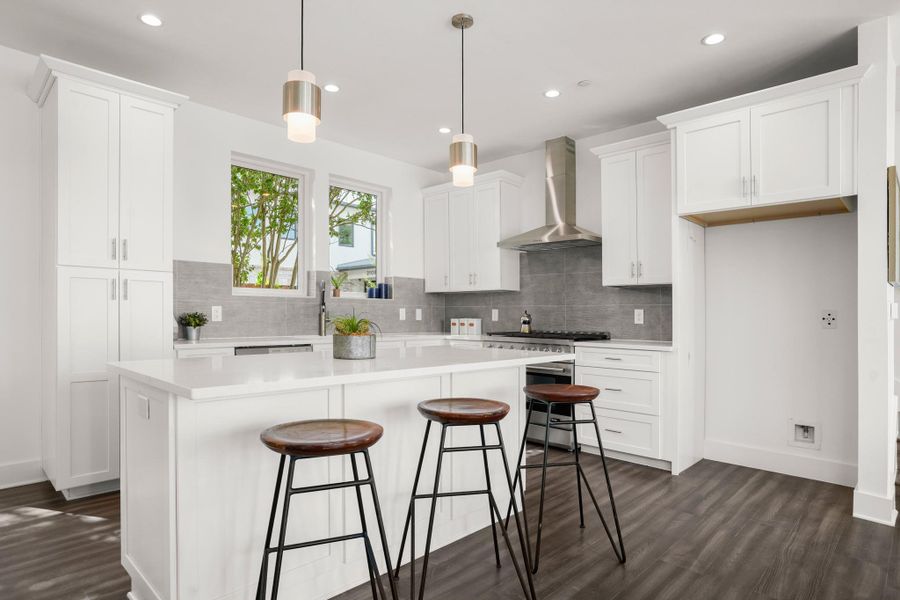A sleek, contemporary kitchen awaits with pristine white cabinetry and an inviting island. A sleek, contemporary kitchen awaits with pristine white cabinetry and an inviting island.