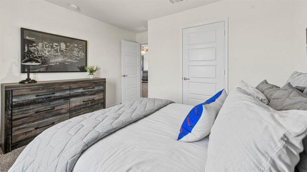 Carpeted bedroom with white walls and a white five-panel interior door