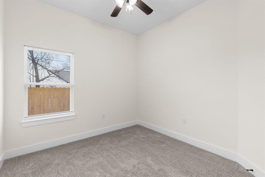 Unfurnished room with carpet and ceiling fan