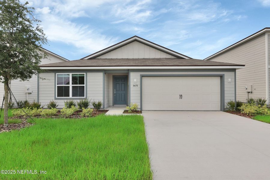 Front exterior of a new home in Wells Landing, Jacksonville, FL, highlighting curb appeal (Image 1).