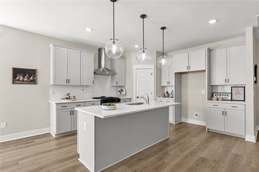 This bright kitchen features an island, ample cabi