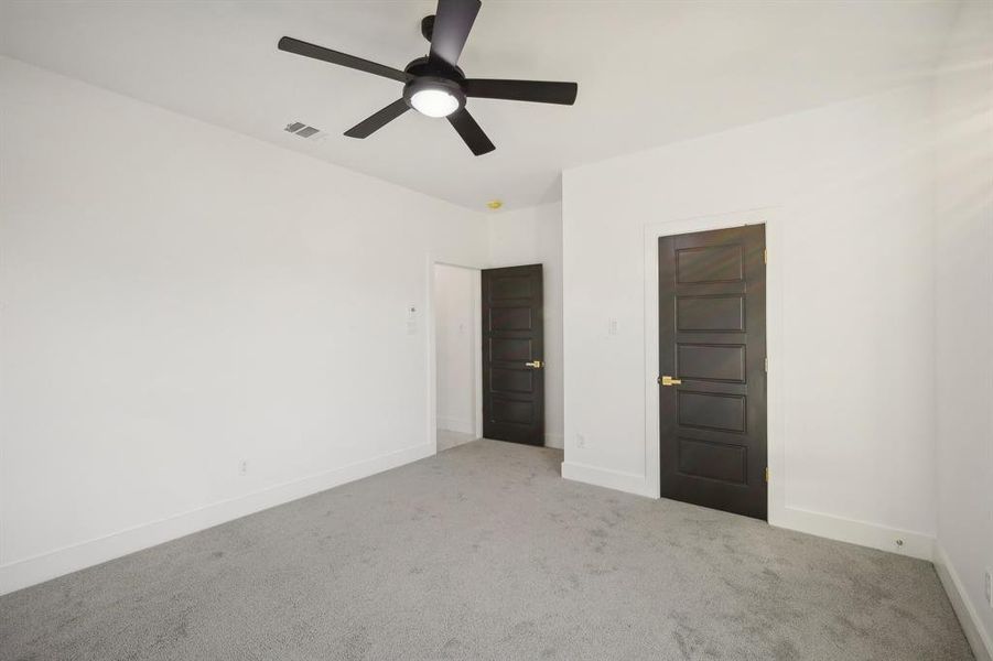 Empty room featuring light carpet and ceiling fan