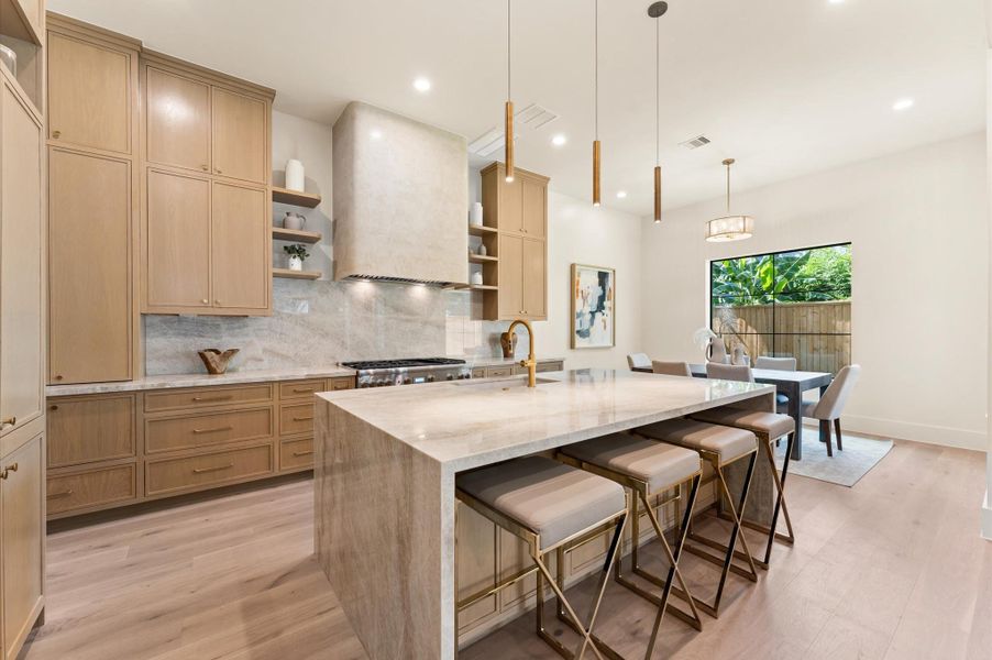 Kitchen includes a built-in paneled refrigerator and Thermador appliances. Kitchen includes a built-in paneled refrigerator and Thermador appliances.