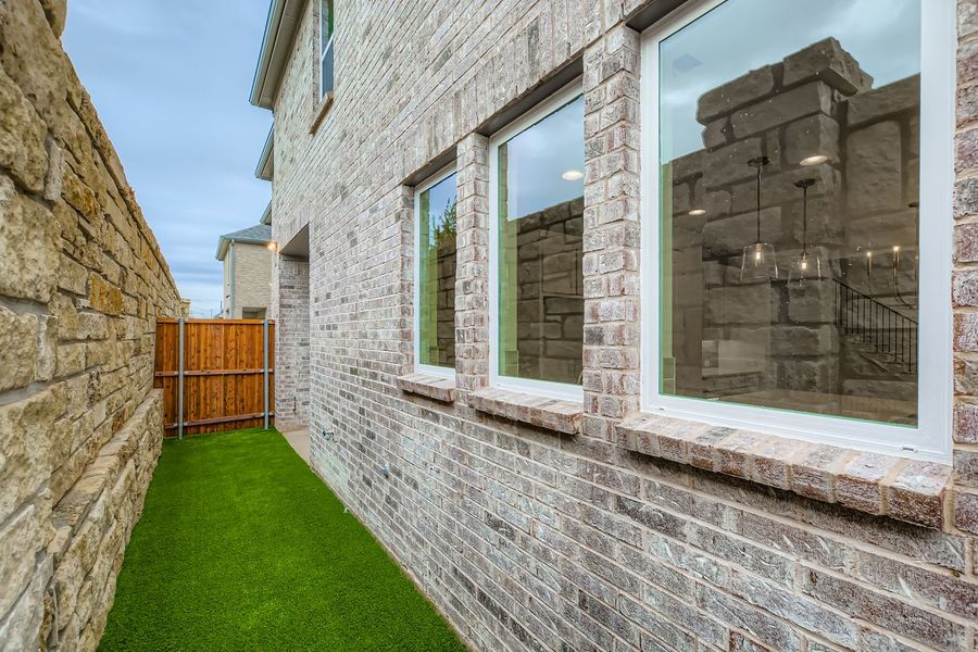 Exterior details and patio area of a home in Castle Hills Northpointe - Townhomes, Lewisville (Image 20).