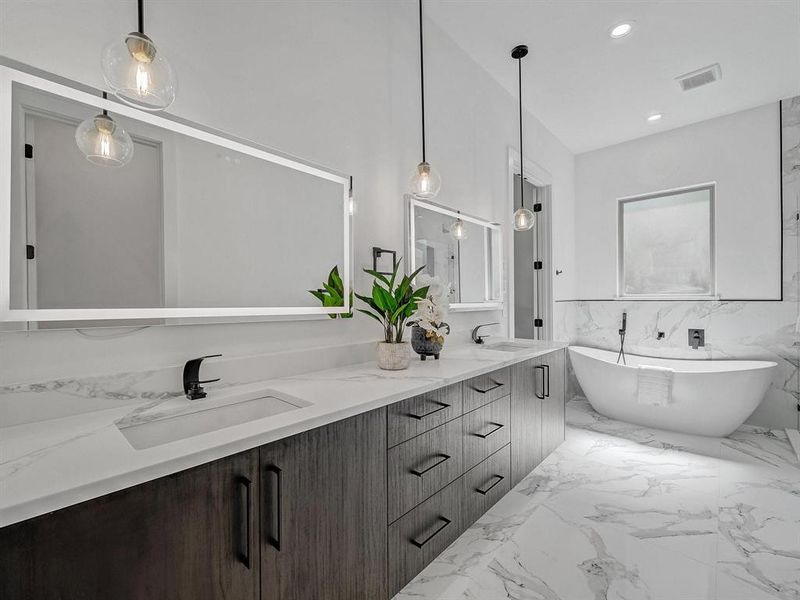 Full bathroom with double vanity, a freestanding tub, marble tiled flooring, wainscoting, and recessed lighting