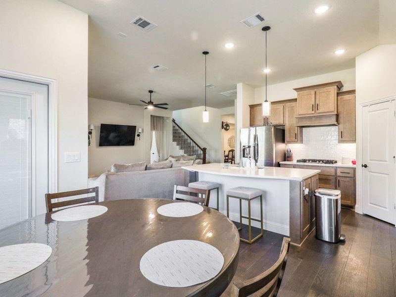 Dining area featuring dark wood-type flooring, ceiling fan, and recessed lighting