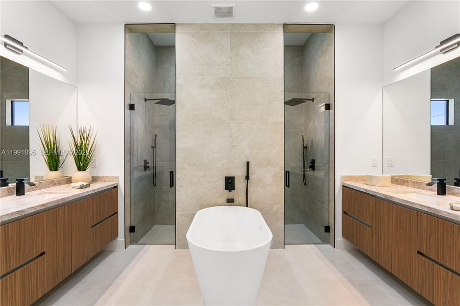 SPA-STYLE BATH featuring dual shower system, freestanding tub & marble vanities SPA-STYLE BATH featuring dual shower system, freestanding tub & marble vanities