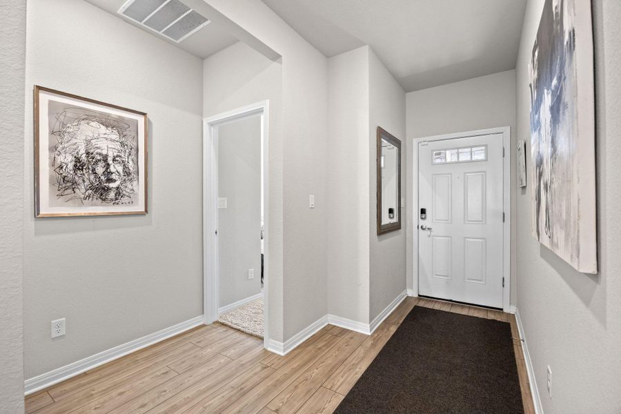 Foyer featuring light wood-style floors and baseboards Foyer featuring light wood-style floors and baseboards