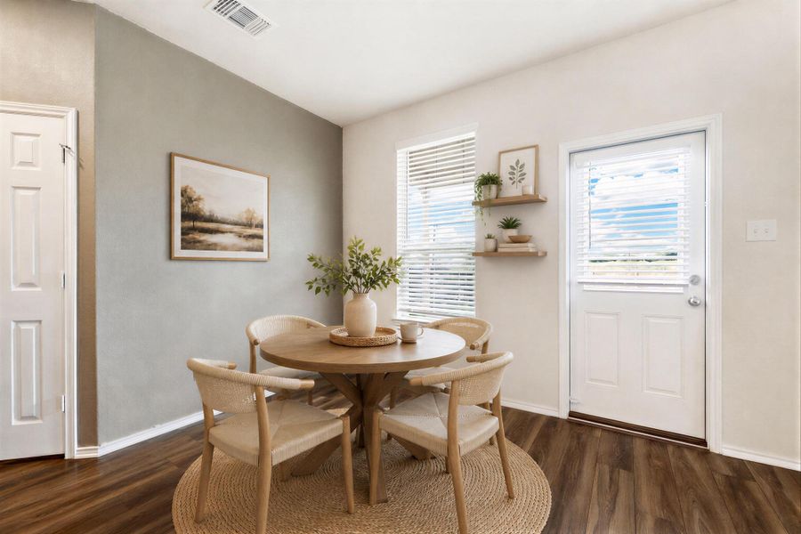 A well-lit eating area features rich wood flooring and a classic white door leading to the exterior. Virtually Staged A well-lit eating area features rich wood flooring and a classic white door leading to the exterior. Virtually Staged