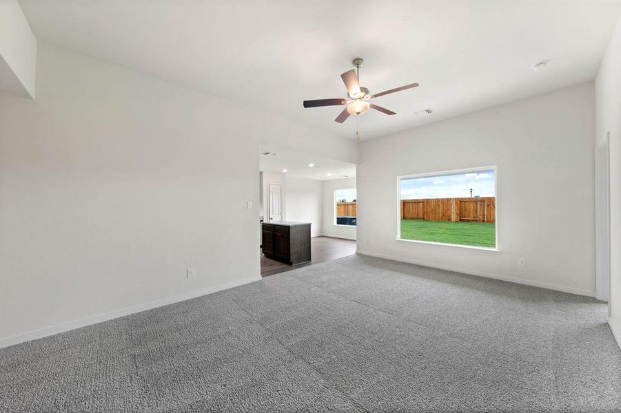 Unfurnished living room featuring dark carpet, a ceiling fan, and recessed lighting Unfurnished living room featuring dark carpet, a ceiling fan, and recessed lighting