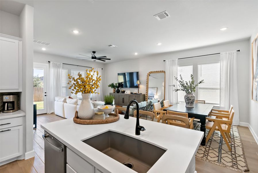 Kitchen featuring white cabinets, ceiling fan, light wood-type flooring, recessed lighting, and open floor plan