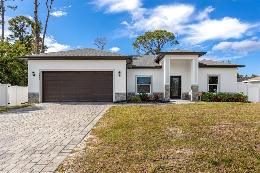 Front exterior of a new home in , North Port, FL, highlighting curb appeal (Image 2). Front exterior of a new home in , North Port, FL, highlighting curb appeal (Image 2).