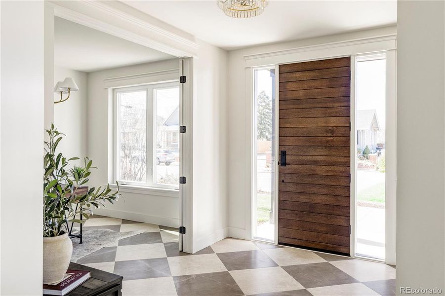 Light-filled entry with statement tile and modern wood door