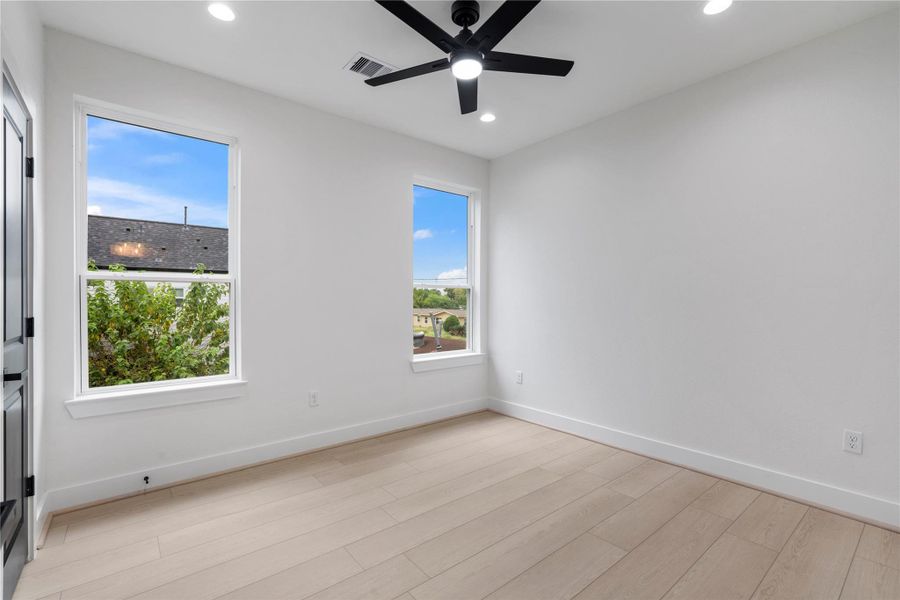 Secondary bedroom with tall windows and clean architectural lines. Secondary bedroom with tall windows and clean architectural lines.