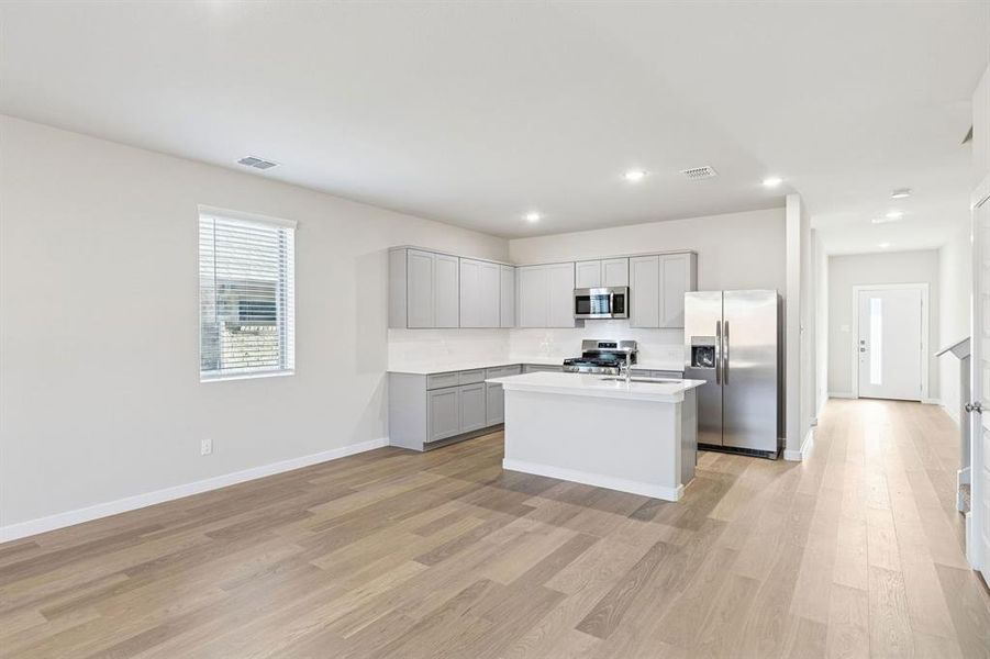 Kitchen and Dining Room in the Haylee home plan by Trophy Signature Homes - REPRESENTATIVE PHOTO