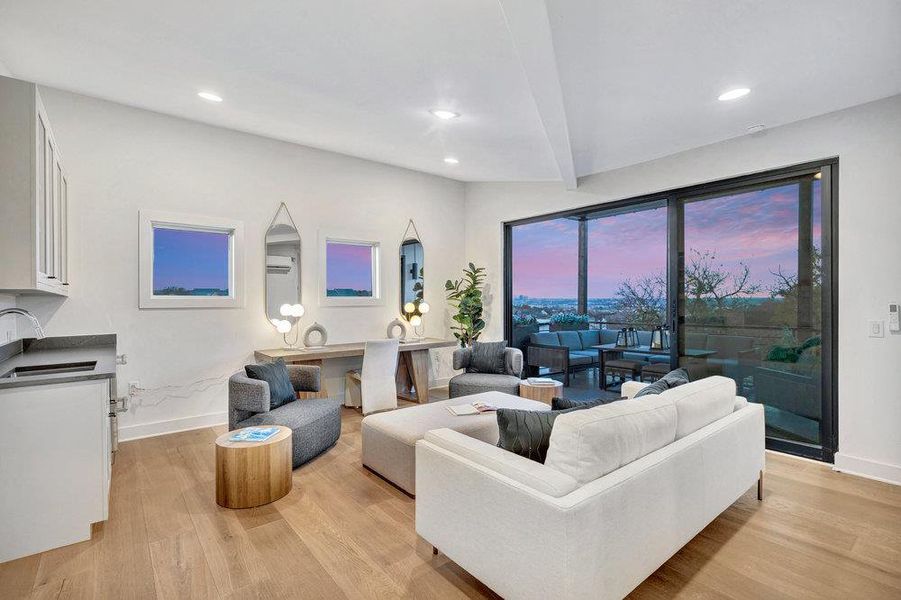 Living room featuring light wood-type flooring and recessed lighting