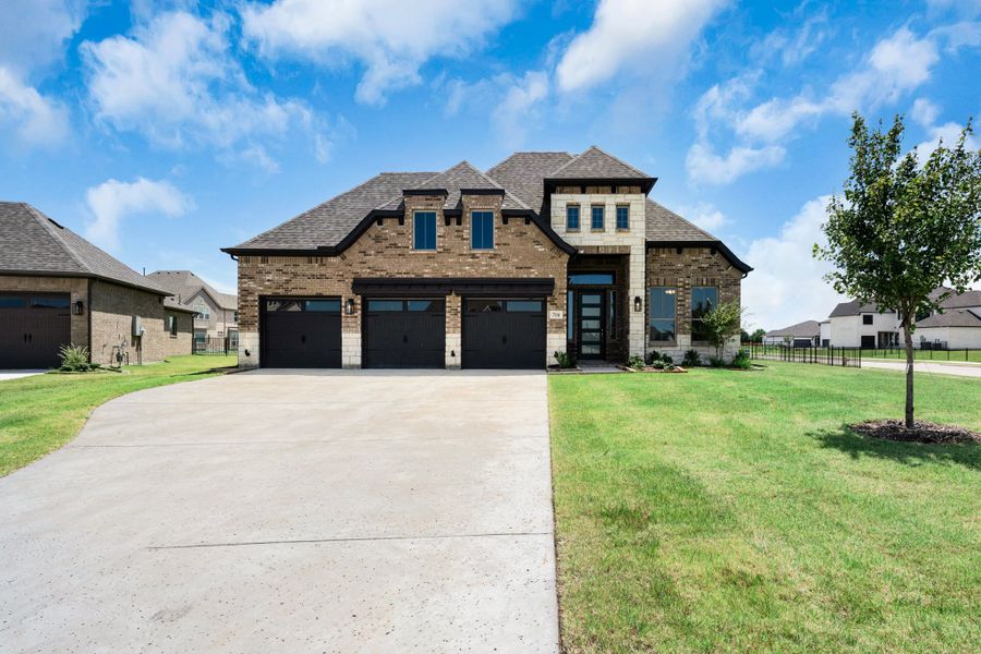 Front exterior of a new home in Heath Golf and Yacht Club, Heath, TX, highlighting curb appeal (Image 16). Front exterior of a new home in Heath Golf and Yacht Club, Heath, TX, highlighting curb appeal (Image 16).