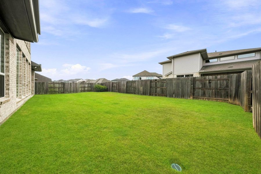 The expansive backyard offers a blank canvas for creating a personalized outdoor retreat, with ample room for a resort-style pool, outdoor living area, play space or beautifully landscaped gardens designed around your lifestyle.