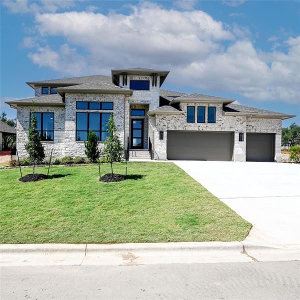 Prairie-style home with concrete driveway, a shingled roof, a front lawn, brick siding, and a garage Prairie-style home with concrete driveway, a shingled roof, a front lawn, brick siding, and a garage