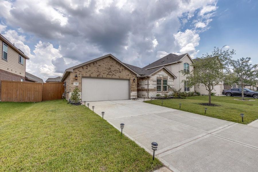 Front exterior of a new home in Sierra Vista, Iowa Colony, TX, highlighting curb appeal (Image 1). Front exterior of a new home in Sierra Vista, Iowa Colony, TX, highlighting curb appeal (Image 1).