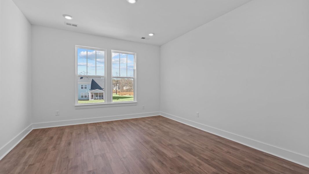 First-class hardwood floors and tasteful finishes elevate the private retreat of this exceptional primary suite