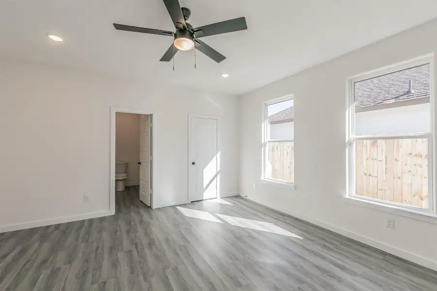 Unfurnished bedroom featuring baseboards, wood finished floors, and recessed lighting