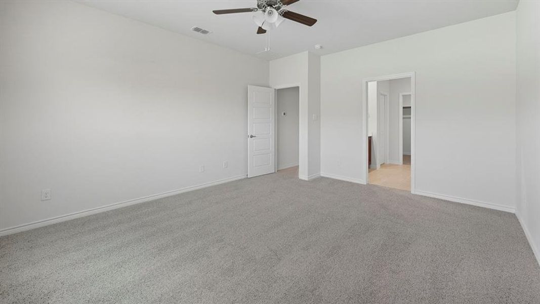 Unfurnished bedroom with light carpet and ceiling fan