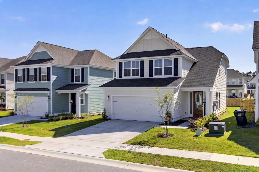 Front exterior of a new home in High Point at Foxbank, Moncks Corner, SC, highlighting curb appeal (Image 24). Front exterior of a new home in High Point at Foxbank, Moncks Corner, SC, highlighting curb appeal (Image 24).