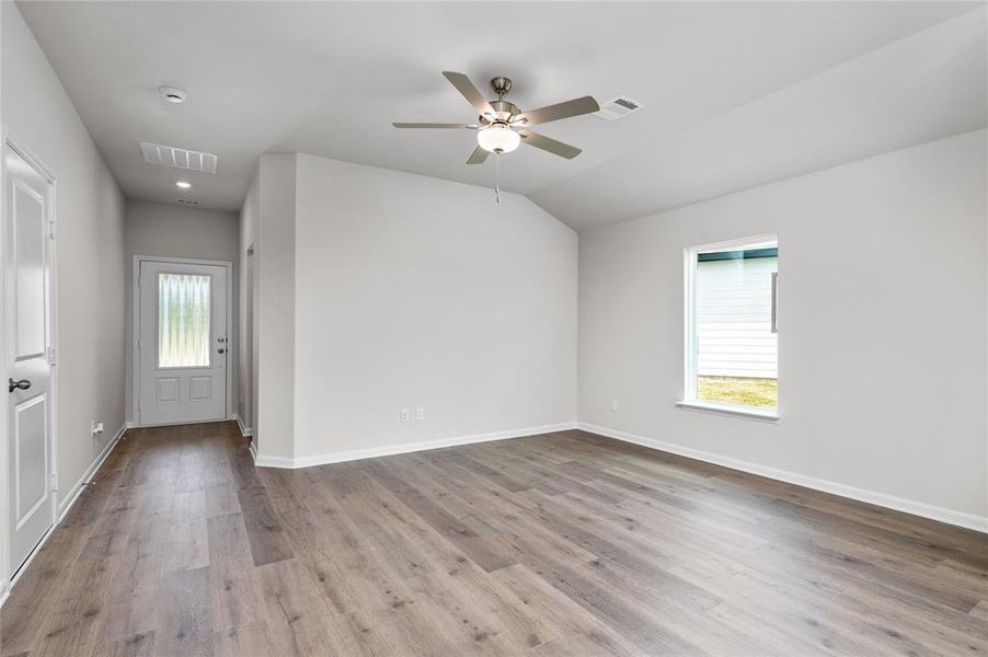 Foyer with light wood-type flooring, healthy amount of natural light, ceiling fan, and lofted ceiling Foyer with light wood-type flooring, healthy amount of natural light, ceiling fan, and lofted ceiling
